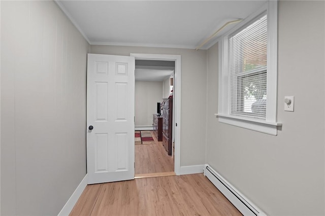 12 Elmore Ave, North Providence, RI 02911 - hallway with light wood-style floors and a baseboard heating unit