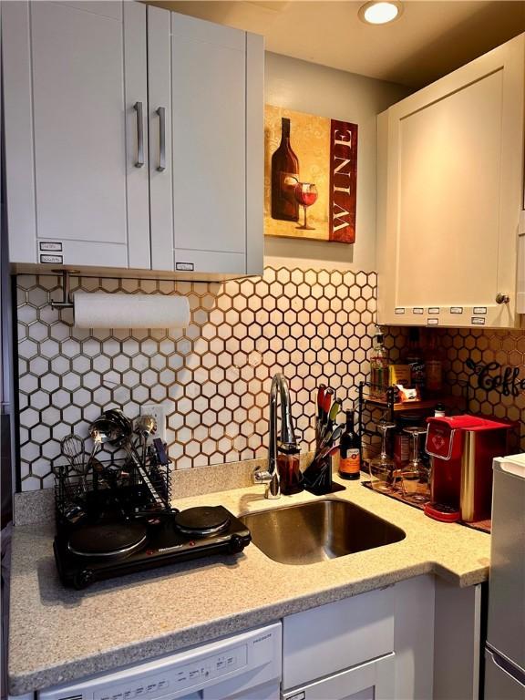 65 Weybosset St Unit 314, Providence, RI 02903 - kitchen with white cabinets, tasteful backsplash, white dishwasher, and light stone countertops