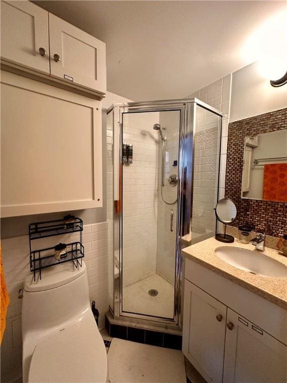 65 Weybosset St Unit 314, Providence, RI 02903 - bathroom with tile walls, vanity, a shower stall, and tile patterned flooring