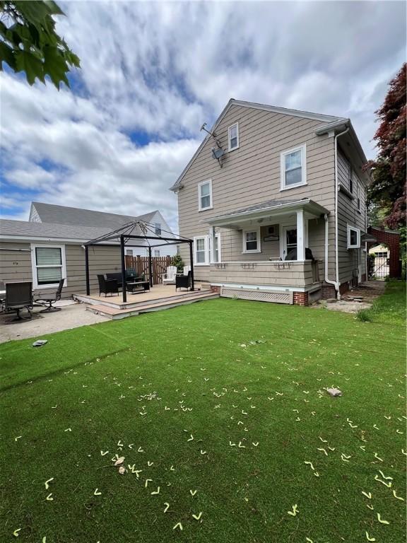 55 Greylock Ave, Cranston, RI 02910 - rear view of property featuring a gazebo, a lawn, a wooden deck, and a patio area