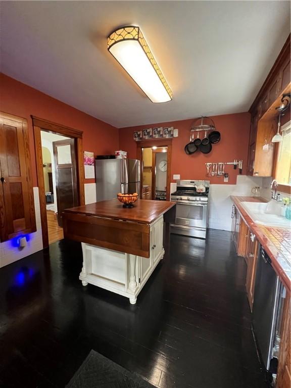 55 Greylock Ave, Cranston, RI 02910 - kitchen featuring appliances with stainless steel finishes, dark wood finished floors, butcher block countertops, and white cabinetry