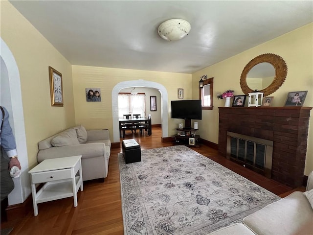 55 Greylock Ave, Cranston, RI 02910 - living area featuring arched walkways, wood finished floors, and a fireplace