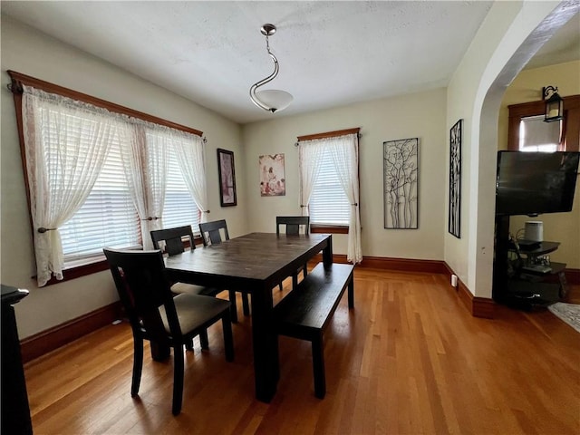55 Greylock Ave, Cranston, RI 02910 - dining area with healthy amount of natural light, light wood-style floors, and arched walkways