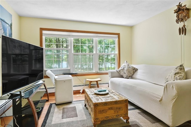 6 Ferris Dr, Coventry, RI 02816 - living area with healthy amount of natural light, baseboard heating, and wood finished floors