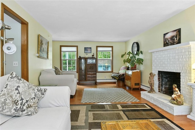 6 Ferris Dr, Coventry, RI 02816 - living room featuring a fireplace, baseboard heating, wood finished floors, and a baseboard radiator