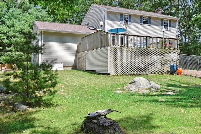 6 Ferris Dr, Coventry, RI 02816 - rear view of house featuring a chimney, a lawn, and a wooden deck