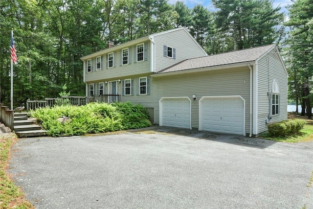 6 Ferris Dr, Coventry, RI 02816 - colonial home with a deck, an attached garage, asphalt driveway, and a chimney