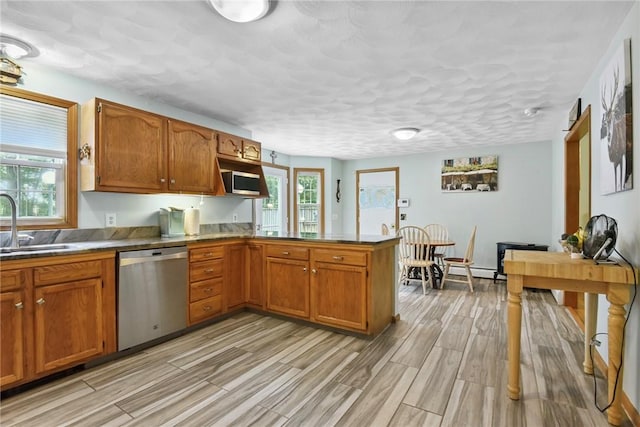 6 Ferris Dr, Coventry, RI 02816 - kitchen with stainless steel dishwasher, a peninsula, brown cabinets, and light wood finished floors