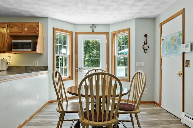 6 Ferris Dr, Coventry, RI 02816 - dining area with a baseboard heating unit and light wood-type flooring