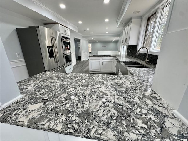 20 Biscuit Hill Rd, Foster, RI 02825 - kitchen featuring a peninsula, appliances with stainless steel finishes, dark stone counters, recessed lighting, and ornamental molding
