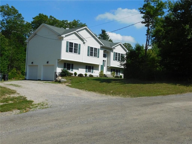476 Ledge Rd, Coventry, RI 02816 - bi-level home featuring a garage, driveway, and a front yard