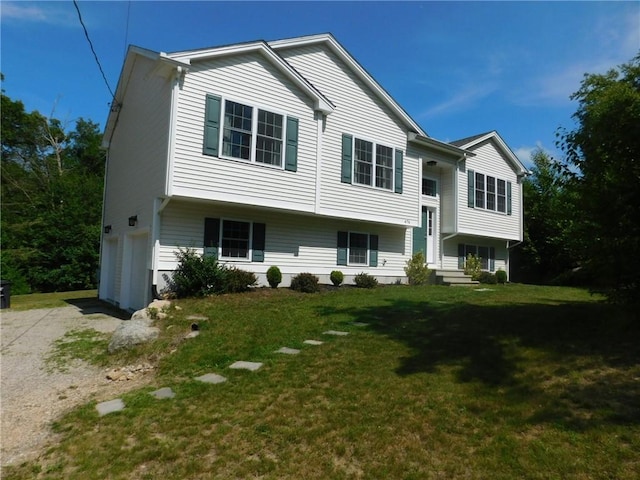 476 Ledge Rd, Coventry, RI 02816 - split foyer home with gravel driveway, a front lawn, and a garage