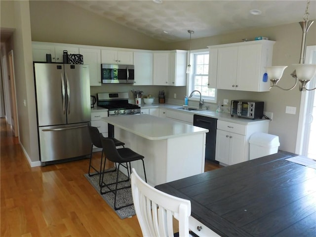 476 Ledge Rd, Coventry, RI 02816 - kitchen featuring appliances with stainless steel finishes, wood finished floors, white cabinets, and lofted ceiling