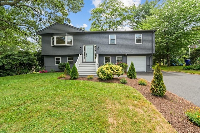 7 Antony Ave, Bristol, RI 02809 - raised ranch featuring an attached garage, driveway, and a front lawn