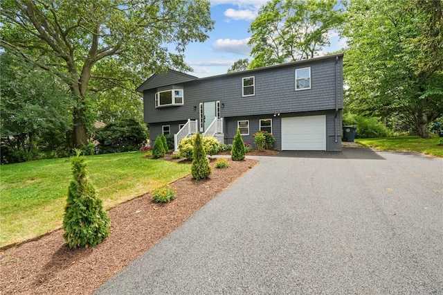 7 Antony Ave, Bristol, RI 02809 - split foyer home featuring a garage, a front lawn, and asphalt driveway
