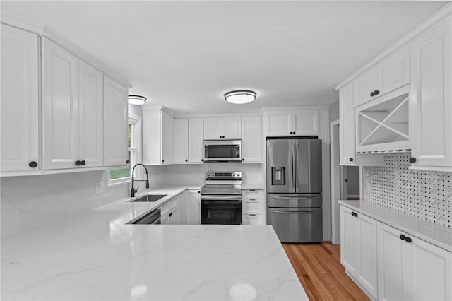 7 Antony Ave, Bristol, RI 02809 - kitchen featuring stainless steel appliances, white cabinetry, backsplash, and light stone countertops