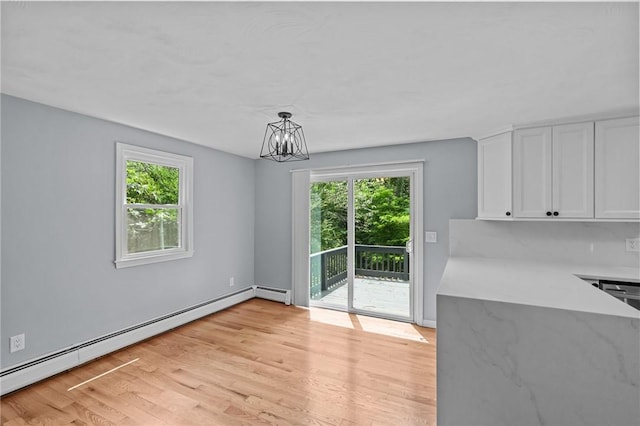 7 Antony Ave, Bristol, RI 02809 - unfurnished dining area featuring a baseboard heating unit, a chandelier, and light wood-type flooring