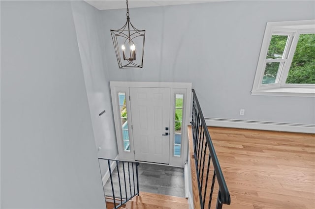 7 Antony Ave, Bristol, RI 02809 - foyer entrance featuring a baseboard radiator, wood finished floors, plenty of natural light, and a chandelier