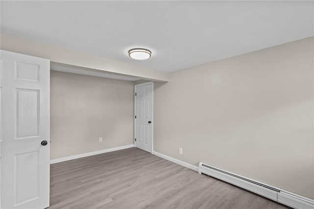 7 Antony Ave, Bristol, RI 02809 - below grade area featuring a baseboard heating unit and wood finished floors