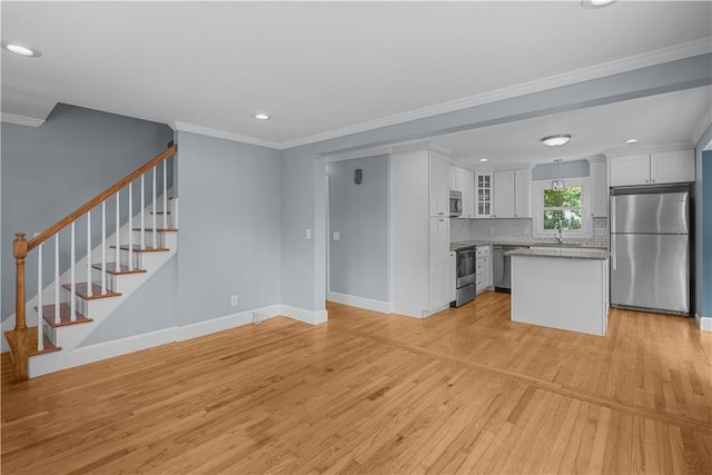 14 Gladding St, Bristol, RI 02809 - unfurnished living room featuring light wood-style flooring, recessed lighting, ornamental molding, and stairs