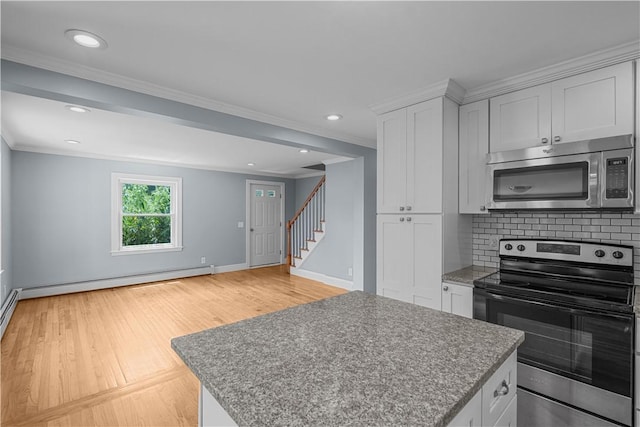 14 Gladding St, Bristol, RI 02809 - kitchen with stainless steel appliances, crown molding, a baseboard radiator, decorative backsplash, and a center island