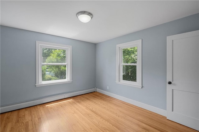 14 Gladding St, Bristol, RI 02809 - empty room with baseboard heating and wood finished floors