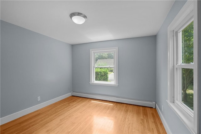 14 Gladding St, Bristol, RI 02809 - empty room featuring a baseboard heating unit and light wood-style floors