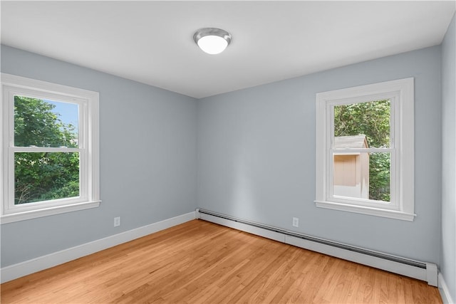 14 Gladding St, Bristol, RI 02809 - empty room with baseboard heating and light wood finished floors