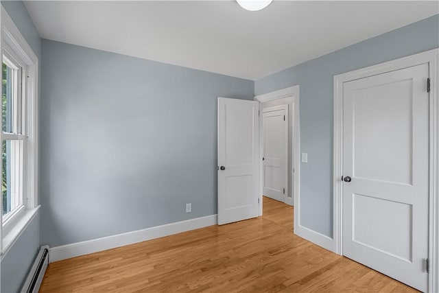 14 Gladding St, Bristol, RI 02809 - unfurnished bedroom featuring a baseboard heating unit and light wood-type flooring