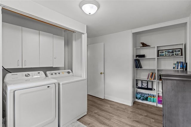 190 White Ave, Warwick, RI 02889 - laundry area featuring washing machine and clothes dryer, light wood-type flooring, and cabinet space
