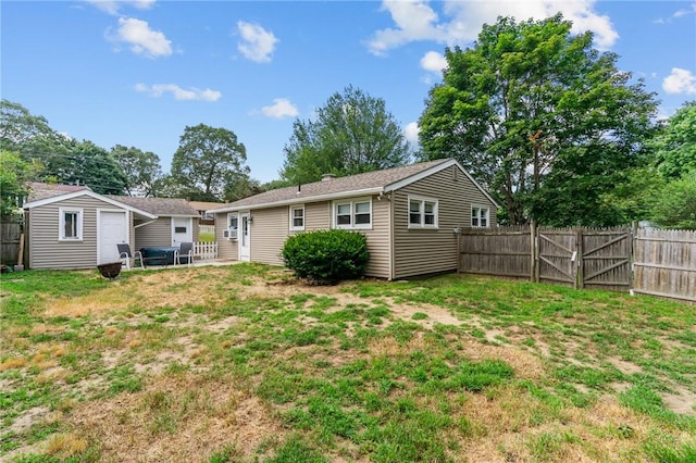 190 White Ave, Warwick, RI 02889 - rear view of property with a fenced backyard, an outdoor structure, and a gate