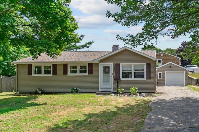 190 White Ave, Warwick, RI 02889 - view of front of house featuring asphalt driveway, an outbuilding, a chimney, a detached garage, and roof with shingles