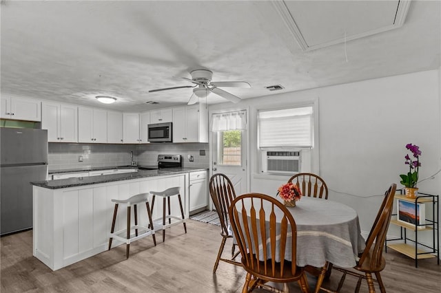 190 White Ave, Warwick, RI 02889 - dining space with attic access, cooling unit, ceiling fan, and light wood-type flooring