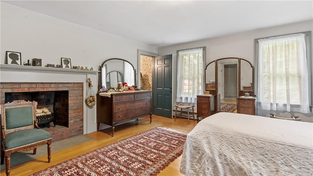 12 Lampercock Ln, Lincoln, RI 02865 - bedroom with wood finished floors, baseboard heating, and a fireplace