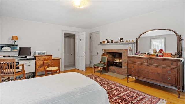 12 Lampercock Ln, Lincoln, RI 02865 - bedroom with wood finished floors, a fireplace, and an office area