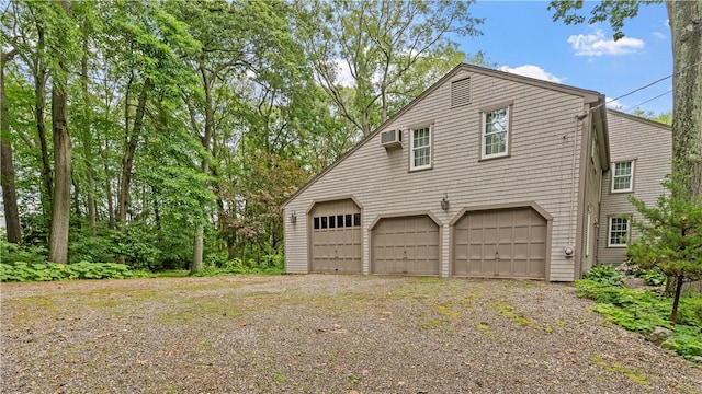 12 Lampercock Ln, Lincoln, RI 02865 - view of side of home featuring a wall unit AC and a garage