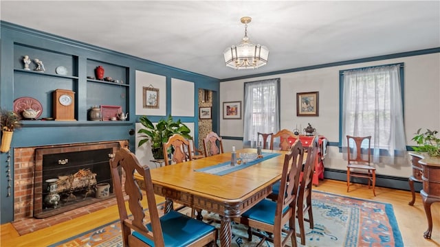 12 Lampercock Ln, Lincoln, RI 02865 - dining room with crown molding, a chandelier, baseboard heating, and wood finished floors