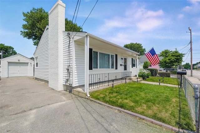 62 Bristol Ave, Pawtucket, RI 02861 - view of front of home with an outdoor structure, asphalt driveway, a chimney, and a detached garage