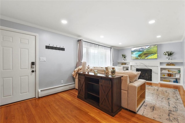 62 Bristol Ave, Pawtucket, RI 02861 - living room with baseboard heating, crown molding, wood finished floors, a premium fireplace, and recessed lighting