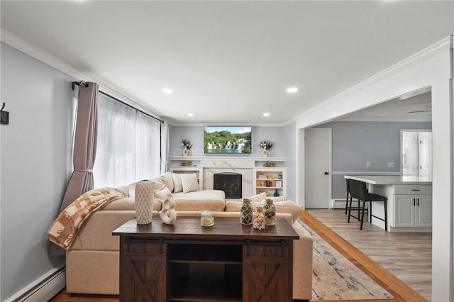 62 Bristol Ave, Pawtucket, RI 02861 - living room featuring baseboard heating, light wood finished floors, ornamental molding, a high end fireplace, and recessed lighting