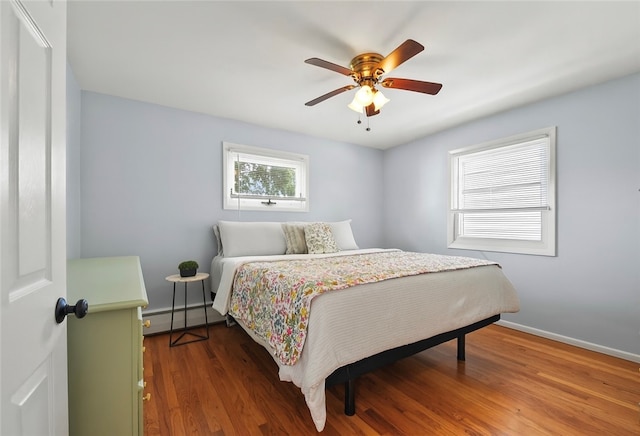 62 Bristol Ave, Pawtucket, RI 02861 - bedroom featuring a baseboard heating unit, wood finished floors, and a ceiling fan