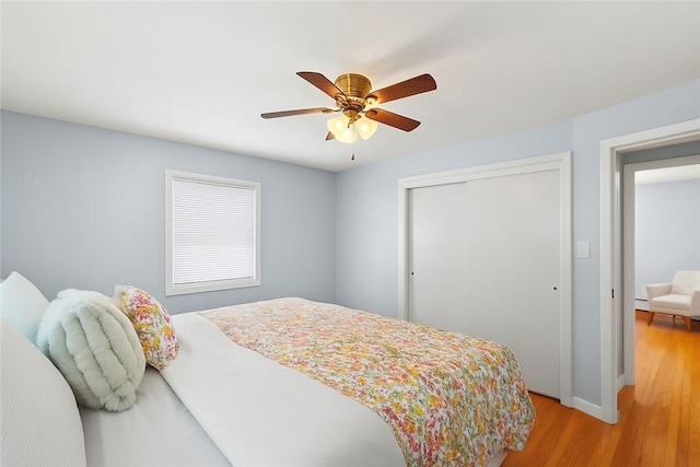 62 Bristol Ave, Pawtucket, RI 02861 - bedroom with a closet, light wood-style flooring, a ceiling fan, and a baseboard radiator