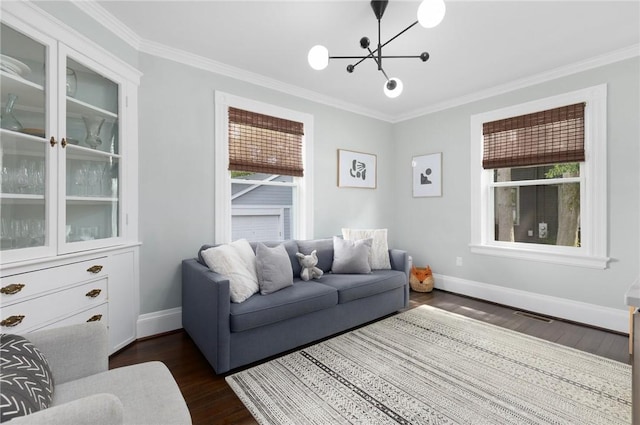 157 Arnold Ave, Cranston, RI 02905 - living room with dark wood-style flooring, healthy amount of natural light, crown molding, and a chandelier
