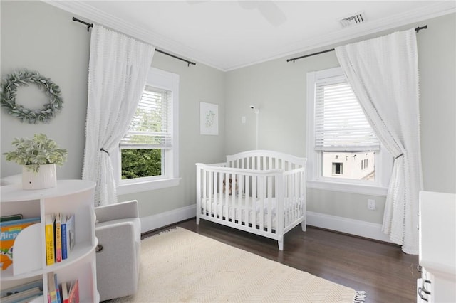 157 Arnold Ave, Cranston, RI 02905 - bedroom featuring crown molding, wood finished floors, and a crib
