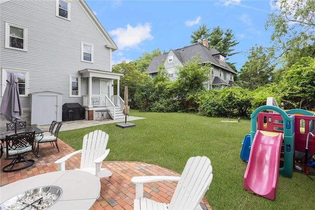 157 Arnold Ave, Cranston, RI 02905 - view of grassy yard featuring a patio, an outdoor fire pit, and a playground