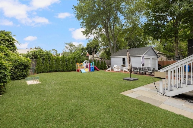 157 Arnold Ave, Cranston, RI 02905 - fenced backyard featuring an outbuilding, a playground, and a patio