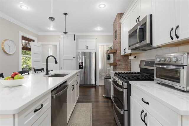 157 Arnold Ave, Cranston, RI 02905 - kitchen featuring appliances with stainless steel finishes, ornamental molding, dark wood-style flooring, white cabinetry, and backsplash