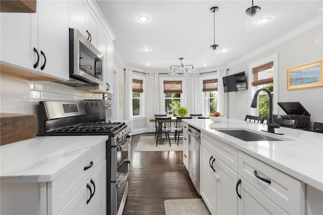 157 Arnold Ave, Cranston, RI 02905 - kitchen featuring appliances with stainless steel finishes, crown molding, a chandelier, recessed lighting, and dark wood-type flooring