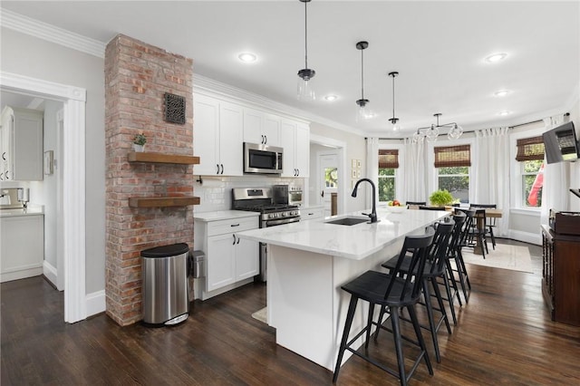 157 Arnold Ave, Cranston, RI 02905 - kitchen with appliances with stainless steel finishes, a breakfast bar, ornamental molding, dark wood finished floors, and white cabinetry