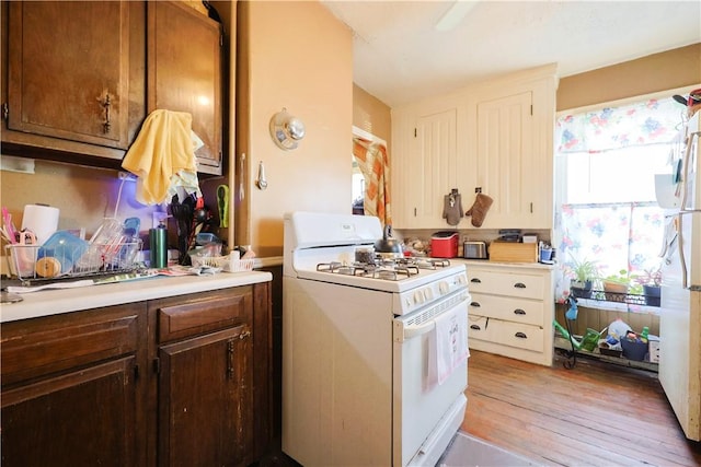 10 Walnut St, East Providence, RI 02914 - kitchen with white appliances, light countertops, and light wood-style floors
